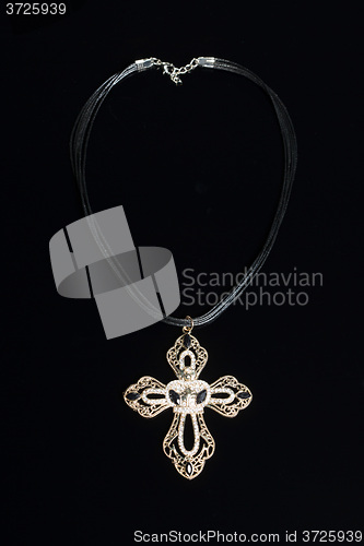 Image of necklace with cross isolated on black background