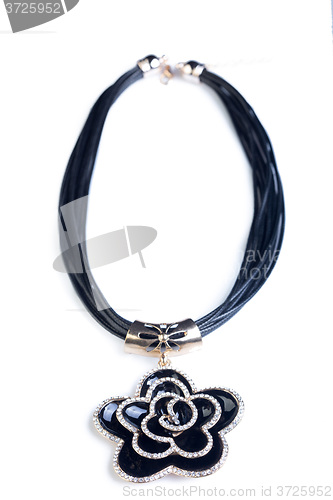 Image of necklace. black flower