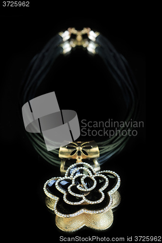 Image of necklace. black flower