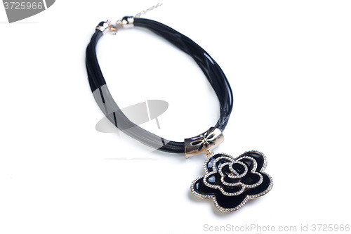 Image of necklace. black flower