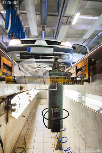 Image of Car on service platform in garage.