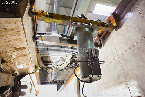 Image of Car on service platform in garage.