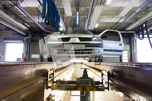 Image of Car on service platform in garage.