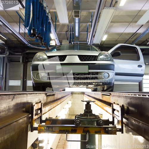 Image of Car on service platform in garage.