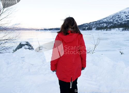 Image of Woman by frozen lake