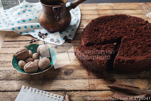 Image of Chocolate cake, coffee and cinnamon sticks