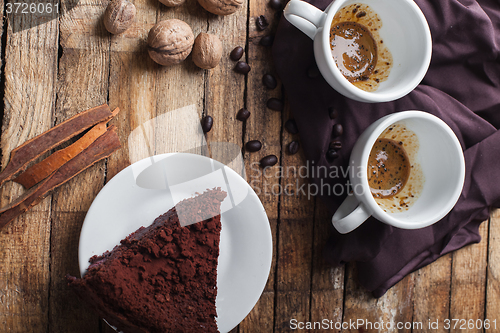 Image of Chocolate cake, coffee and cinnamon sticks