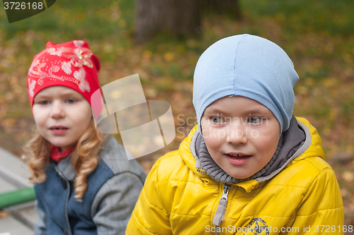 Image of two children in a park in autumn, portrait