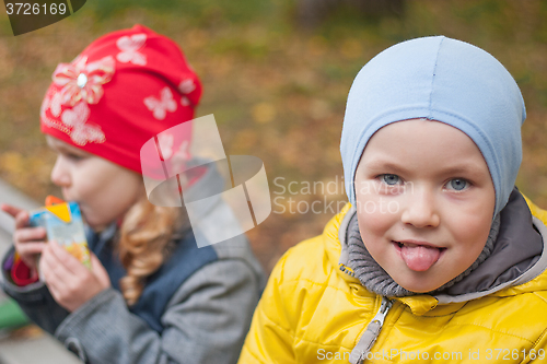 Image of two children in a park in autumn, portrait