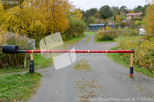 Image of one small road with a road barriier