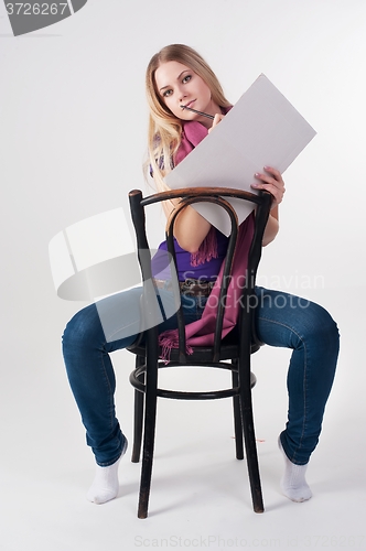 Image of Pretty female painter sits on chair