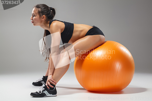 Image of The young, beautiful, sports girl doing exercises on a fitball 