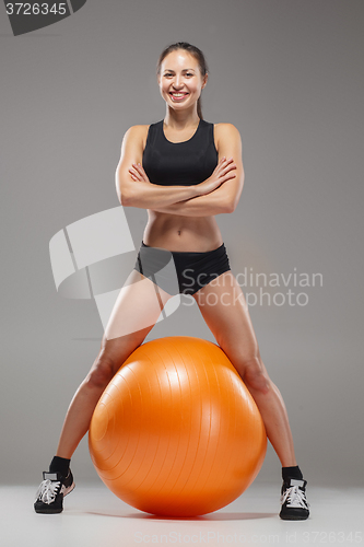 Image of The young, beautiful, sports girl doing exercises on a fitball 