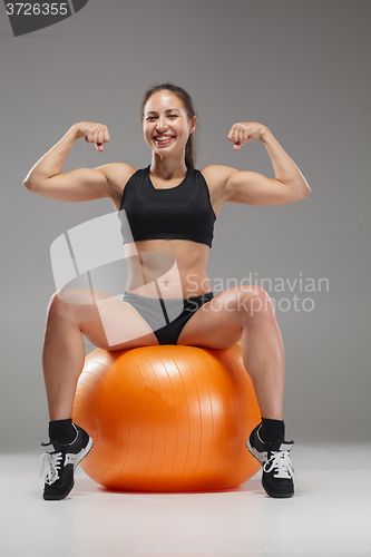 Image of The young, beautiful, sports girl doing exercises on a fitball 