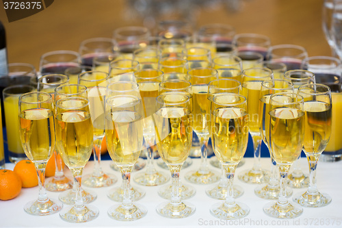 Image of Glasses with champagne on the party table. lot of alcohol