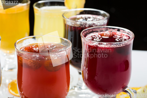 Image of mulled wine. fruit or berry drink. alcohol winter. against a dark background