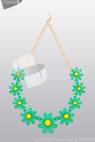 Image of plastic necklace. five beige flower