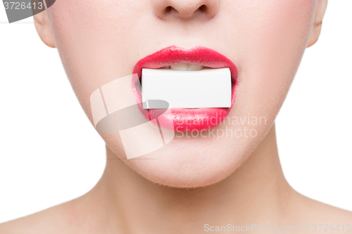 Image of girl holds in teeth white form. isolated