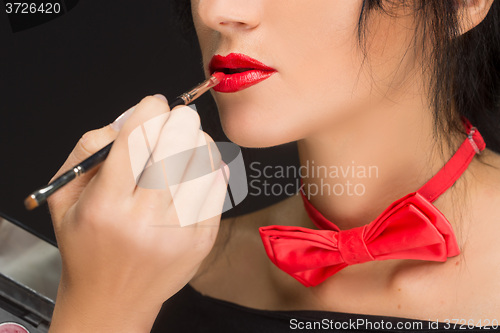 Image of Lips of a girl with artist doing makeup