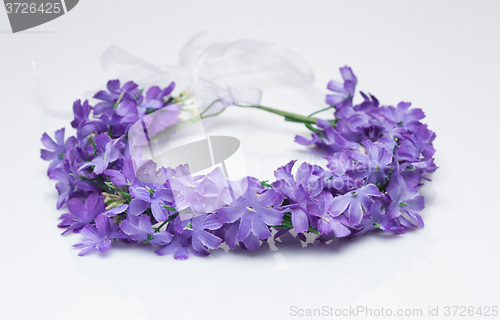 Image of tiara of artificial  roses on a light background