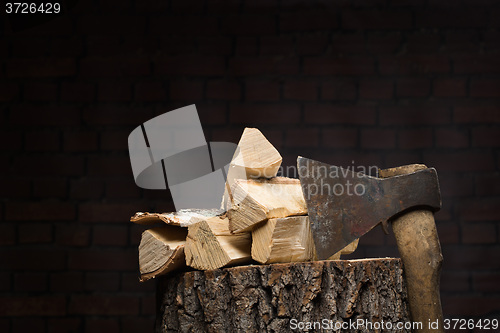 Image of birch firewood, old rusty ax 