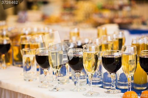 Image of Glasses with champagne on the party table. lot of alcohol