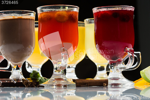 Image of mulled wine. fruit or berry drink. alcohol winter. against a dark background