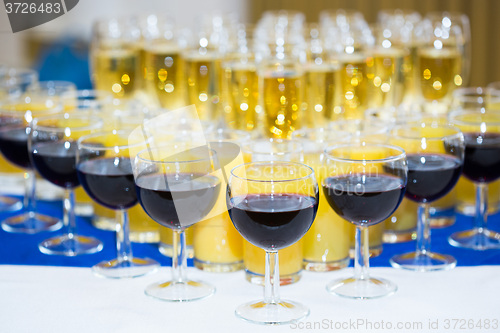 Image of Glasses with champagne on the party table. lot of alcohol