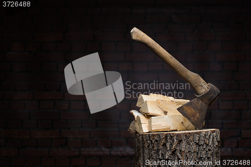 Image of birch firewood, old rusty ax 