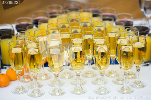 Image of Glasses with champagne on the party table. lot of alcohol