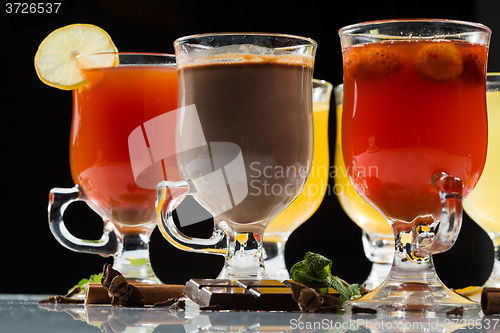 Image of mulled wine. fruit or berry drink. alcohol winter. against a dark background