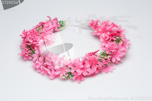 Image of tiara of artificial  roses on a light background