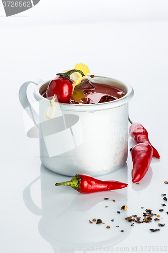 Image of bloody mary cocktail in the iron circle on a white background