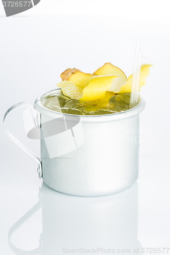 Image of Whiskey with ice in the iron circle isolated on white. lemon zest