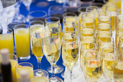 Image of Glasses with champagne on the party table. lot of alcohol