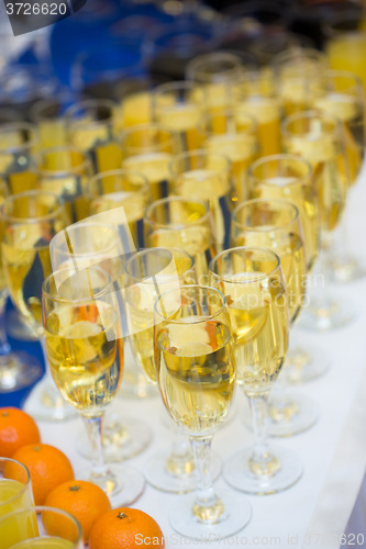 Image of Glasses with champagne on the party table. lot of alcohol