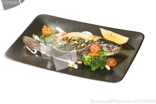 Image of Stuffed seabass on a black plate 