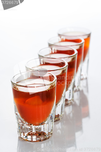 Image of Beautiful shot glasses back lit. red