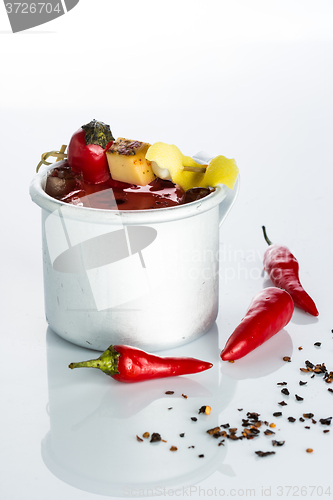 Image of bloody mary cocktail in the iron circle on a white background