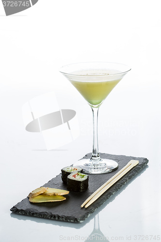 Image of Yellow cocktail with a set of sushi on white background