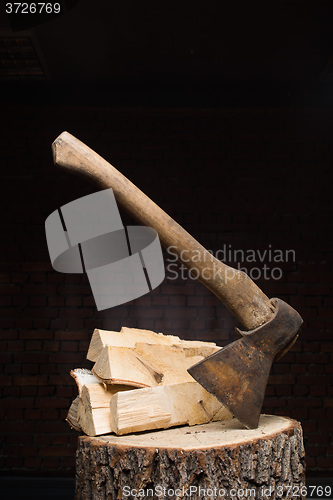 Image of birch firewood, old rusty ax 