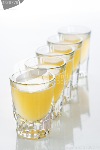 Image of Beautiful shot glasses back lit. yellow