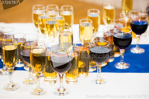 Image of Glasses with champagne on the party table. lot of alcohol