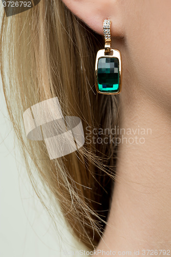 Image of close up of woman wearing shiny diamond earrings