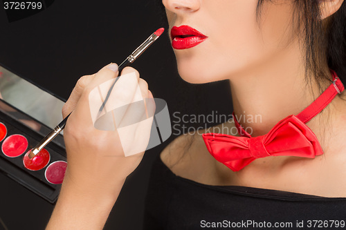 Image of Lips of a girl with artist doing makeup