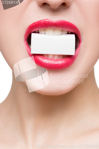 Image of girl holds in teeth white form. isolated