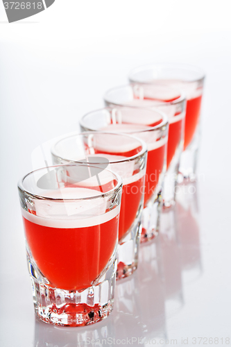 Image of Beautiful shot glasses back lit. red