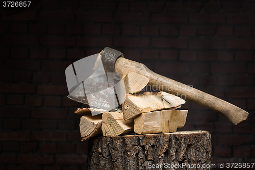 Image of birch firewood, old rusty ax 