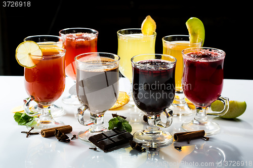 Image of mulled wine. fruit or berry drink. alcohol winter. against a dark background