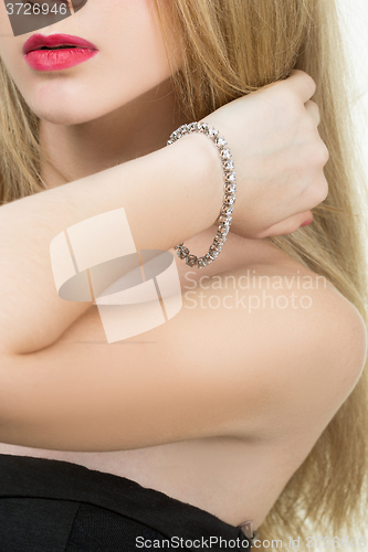 Image of beautiful young blond woman in multiple bracelets